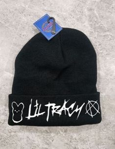 a black beanie with white writing on the front and bottom, it says lit tray