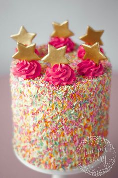 a birthday cake with sprinkles and stars on top