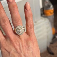 a woman's hand with a diamond ring on it