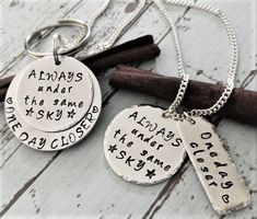 "Hand Stamped Military Necklace and Key Chain, Always Under The Same Sky Keychain,Deployment Gift,Military Couples Gift,Army Wife Necklace DISCOUNT IF YOU PURCHASE BOTH This piece features KEY CHAIN DESCRIPTION ■ One Hand stamped 1 1/4\" aluminum disc that reads \"ONE DAY CLOSER\" ■ One hand stamped 1\" Aluminum Disc that reads \" Always under the same sky\" NECKLACE DESCRIPTION ■ One Hand stamped 1\" aluminum disc that reads \"Always under the same sky\" ■ One rectangular Aluminum bar that read Always Under The Same Sky, Military Necklace, Under The Same Sky, Christmas Ideas For Boyfriend, Marines Girlfriend, Military Couples, Deployment Gifts, Military Girlfriend, Army Gifts