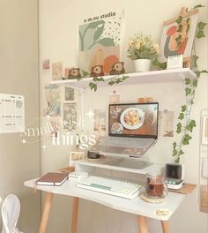 a laptop computer sitting on top of a white desk