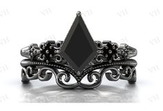 a black diamond ring with filigrees on it