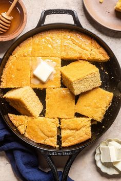 a skillet with squares of cornbread and butter