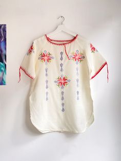 PLEASE NOTE new orders will be shipped after 13th of March due to holiday 💝 please enjoy 15% off the whole collection 💕   Vintage cotton embroidered folklore top from the seventies. Lovely floral embroidery made with pink, red, green and blue threads. Lovely details! Fits for size M or L, but please check measurements to be sure. In a vintage condition, some little signs of use but nothing major. - measured flat - armpit to armpit: 53cm length: 71cm Please compare it with a garment you already own to be sure :) Thank you for visiting my shop <3  { Please read this before shopping } -  Please note that you are buying a vintage garment, garments will not be as new but I check each item very well. Major flaws are always noted in description. Everything is steamed before shipping - All sales Folk Style Peasant Tunic Top With Floral Embroidery, Folk Style Peasant Top With Floral Embroidery, Floral Embroidered Tunic Top For Festival, Bohemian Crew Neck Blouse With Floral Embroidery, Folk Style Short Sleeve Peasant Top With Embroidered Border, Summer Festival Peasant Top With Embroidered Hem, Folk Style Peasant Top With Embroidered Border, Peasant Festival Top With Embroidered Hem, Festival Embroidered Hem Short Sleeve Top