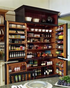 an open pantry with lots of food and condiments on the shelves in it