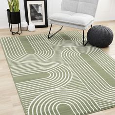 a green rug with white circles on it in front of a chair and potted plant