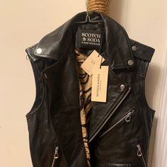 Genuine Leather Sleeveless Sleeveless Biker Outerwear For Spring, Spring Biker Vest In Black, Fitted Sleeveless Leather Jacket, Spring Black Biker Vest, Spring Sleeveless Biker Outerwear, Black Sleeveless Edgy Outerwear, Edgy Black Sleeveless Outerwear, Sleeveless Fitted Biker Outerwear, Fitted Sleeveless Biker Outerwear