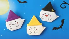 three paper witches on a blue background