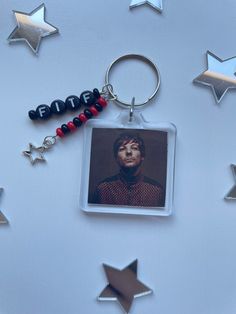 a keychain with an image of a man on it and some stars around it