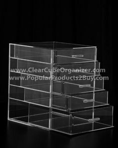 clear acrylic display case with drawers for jewelry and other items on black background