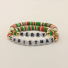 These Christmas bracelets, made from flat polymer clay beads, will bring a festive touch to your look. You can choose any bracelet from the ones shown in the photos or order the full set of three. Additionally, you can personalize your bracelet by adding a name or word of your choice. Each bracelet is handmade to order and customized to your size. These bracelets make a wonderful gift for loved ones or a perfect accessory for the holiday season. Visit my shop to see more options! https://www.etsy.com/BraceletPendantEarri Christmas Clay Bead Bracelets, Name Friendship Bracelets, Christmas Bracelet Ideas, Bracelets Christmas, Heishi Bracelets