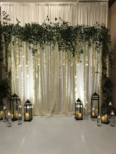 an image of a wedding ceremony setting with candles and greenery on the side wall