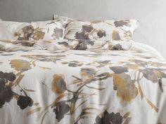 an image of a bed setting with flowers on the comforter and pillowcases