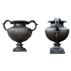 two black vases sitting next to each other