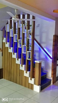 the stairs in this house are decorated with wood and blue glass inserts, along with white tile flooring