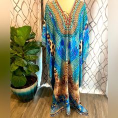 Brand New With Tags True Colours By La Moda One Size Jungle Blue Maxi Swim Cover-Up. Has Jeweled Embellishments, And Tassels, And Has A Front Lace Up Style. See Photos For Up Close Details! Brand New With Tags! Retails For $128 Gorgeous Caftan Cover Up. Hand Wash One Size. Measurements Are: Bust: 52 Waist: 50 Hips: 55 Blue Printed Kaftan For Festivals, Blue Boho Print Kaftan For Festival, Blue Embellished V-neck Kaftan, Blue Boho Print Maxi Kaftan, Beach Long Sleeve Embellished Kaftan, Blue Boho Print Kaftan For Beach Season, Blue Embellished Maxi Dress For Summer, Long Sleeve Embellished Kaftan For Beach, Embellished Long Sleeve Kaftan For The Beach