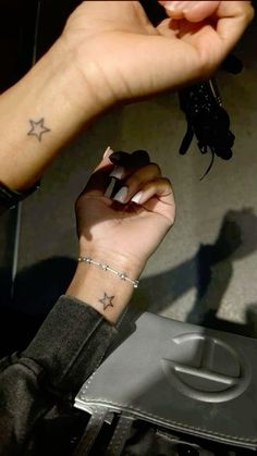 a woman with a star tattoo on her wrist