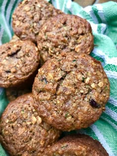 several muffins sitting on top of a green and white towel next to each other