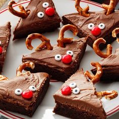 some brownies with chocolate frosting and pretzels in the shape of reindeer noses