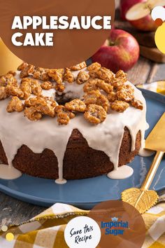 a cake with applesauce and walnuts on top sitting on a blue plate