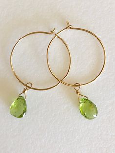 "Lovely apple green genuine peridot pear drops wire wrapped on delicate 1\" 14k gold hoops. Petite faceted peridot briolettes are 7 x 10mm and hang from handmade 1\" 14k gold fill wire hoops. Total drop length is 1 3/4\". Also available in Sterling silver. A lovely sparkly August birthday gift!" Teardrop Peridot Jewelry For Anniversary, Green Peridot Wire Wrapped Jewelry, Green Briolette Wire Wrapped Jewelry, Gold Teardrop Hoop Earrings For May Birthstone, Gold Teardrop Hoop Earrings With Emerald, Teardrop Peridot Jewelry For May Birthstone, Yellow Gold Peridot Teardrop Jewelry, August Birthday, Aquamarine Earrings