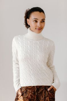 The cable knit turtleneck is the epitome of timelessness. Easily dressed up with the Ellis pants or dressed down with denim, it is just as appropriate for an upscale evening out as it is at school drop off. Knit in LA in a facility well known for luxury brands and crafted from the most sumptuous Italian cashmere, this sweater will stand the test of time. Available in navy, black, cream, and camel in midweight 7-gauge 100% Italian cashmere. Knit in Los Angeles. Cable Knit Turtleneck, Knit Turtleneck, Scarf Headband, Knit Blazer, Drop Off, Cotton Cardigan, Luxury Brands, At School, Womens Activewear