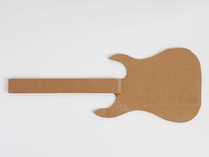 a guitar shaped cardboard cutout on a white background