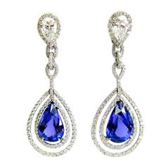 Exquisitely crafted in platinum and diamonds, these double frame tanzanite earrings feature two pear shape diamonds totaling 2.02 carats, pave diamonds totaling 2.57 carats, and two big beautiful tanzanite pear shape stones totaling 14.49 carats. Tanzanite Drop Earrings, Frame Earrings, Blue Diamond Jewelry, Luxurious Jewelry, Vintage Drop Earrings, Pave Diamond Earrings, Tanzanite Jewelry, Tanzanite Earrings, Double Frame