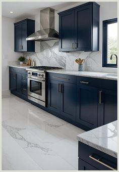 a kitchen with blue cabinets and marble counter tops in the middle of the flooring