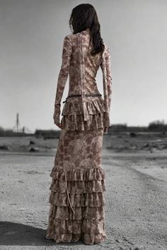 The Nomad Dune Layered Maxi Dress combines an earthy, distressed look with luxurious ruffled layers. Its floor-length silhouette, loose fit, and lace-up front detail evoke a rugged, post-apocalyptic vibe. This dress makes a bold, rebellious statement perfect for daring, avant-garde fashionistas. Features: Material: Cotton, Polyester blend Fit: Slim, flowy silhouette Style: Distressed, Layered, Floor-length Decoration: Ruffled tiers Occasion: Glamorous/Posh, Statement piece Season: Summer/Autumn Layered Maxi Dress, Dress Pant, Post Apocalyptic, New Instagram, Season Summer, Dress Making, Floor Length, Ruffles, Loose Fitting