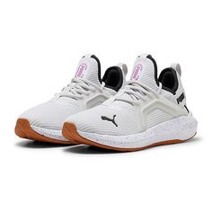 the puma shoes are white and black with pink accents on the upper part of the shoe