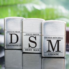 three different types of groomsmen flasks on top of a glass table