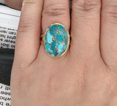 14k gold filled turquoise ring. 14 karat gold filled sterling silver and 13mm x 17.5mm stabilized copper infused turquoise. The band is 4mm. This ring is available in whole sizes. Material: 14k gold filled Sterling Silver Stone Size: 13mm x 17.5mm Coming with gift box RETURN POLICY : For any reason, if you are not satisfied with our product, you may return your order within 10 days from the date of shipment received. The item must be returned in its original condition. Shipping charges are not r Oval Gold Turquoise Ring Fine Jewelry, Adjustable Gold Turquoise Ring With Oval Shape, Adjustable Gold Oval Turquoise Ring, Adjustable 14k Gold Turquoise Ring, Adjustable Gold Turquoise Ring Fine Jewelry, Adjustable Gold Turquoise Ring In Fine Jewelry Style, Gold Oval Turquoise Ring Gift, Oval Gold Turquoise Ring Gift, Gold Turquoise Ring With Large Stone As Gift