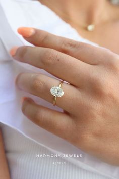 a woman's hand with a diamond ring on it