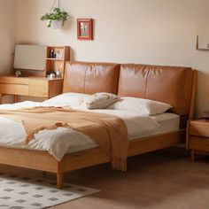 a bed sitting in a bedroom next to a wooden dresser and lamp on top of a hard wood floor