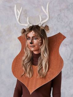 a woman with long blonde hair and antlers on her head