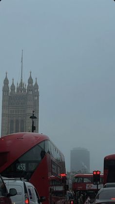 the big ben clock tower towering over the city of london on a foggy day