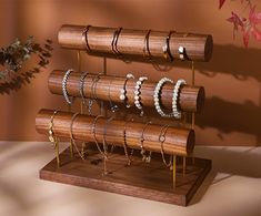 a wooden stand with rings and bracelets on it