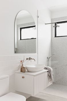 a bathroom with a sink, mirror and toilet