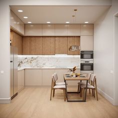 the kitchen is clean and ready to be used for dinner or lunchtime, while the dining table has four chairs around it