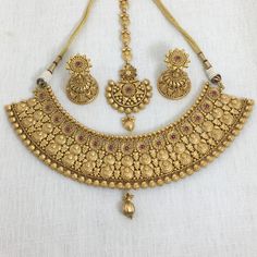 India Gold Necklace, a dazzling piece of Temple Jewelry. This Choker Necklace exudes timeless elegance and is ideal for weddings and special occasions. Crafted in the South Indian tradition, it reflects the rich heritage of Temple Jewelry. Adorn yourself with the intricate designs of this Temple Necklace Set, perfect for making a statement. Whether it's a wedding or a grand celebration, this piece adds a touch of sophistication to your ensemble. *𝐏𝐑𝐎𝐃𝐔𝐂𝐓 𝐃𝐄𝐓𝐀𝐈𝐋* * Material: Brass * Luxury Gold Plated Bollywood Temple Necklace, Luxury Brass Temple Necklace For Ceremonial Occasions, Gold Temple Jewelry Bridal Accessories, Heavy Gold Bridal Accessories For Wedding, Elegant Heavy Gold Bridal Accessories, Elegant Gold Bridal Accessories, Traditional Round Necklace For Wedding, Gold Heavy Bridal Necklace For Wedding, Traditional Round Necklaces For Wedding