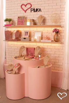 a display in a store filled with lots of pink shoes and accessories on top of round stools