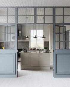 an open kitchen and dining area with blue doors