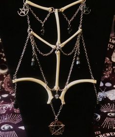 a black mannequin with chains and charms on it