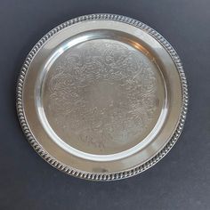 a silver plate with intricate designs on it