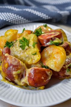 a white plate topped with cooked food on top of a table