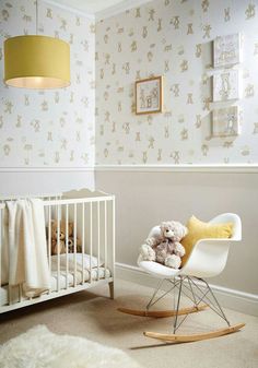 a baby's room with a rocking chair, crib and teddy bear wallpaper