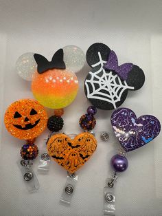 several halloween decorations are arranged on a white surface with black, orange and purple accents