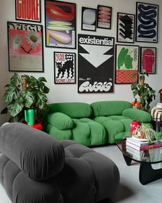 a living room filled with lots of green furniture