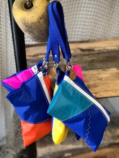 "Bright, colorful wristlets that are sure to delight any nautical enthusiast!  These lightweight travel companions are perfect for your small essentials while on the go. Each wristlet measures approximately 6\"h x 9\"w and comes fully lined with a water resistant fabric, giving added protection to your belongings.  Wrist  straps are constructed from polypropylene webbing and are attached using solid brass nickel swivel snaps." Multicolor Wristlet With Zipper Pouch As Gift, Multicolor Zipper Pouch Wristlet As Gift, Multicolor Zipper Pouch Wristlet For Gift, Multicolor Wristlet For Everyday Use, Blue Pouch Wristlet As Gift, Blue Wristlet With Zipper Pouch For Travel, Multicolor Zipper Pouch Wristlet, Recycled Sail Bags, Recycled Sailcloth